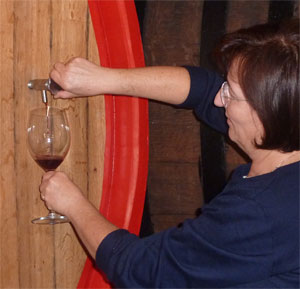 taking wine from barrel.